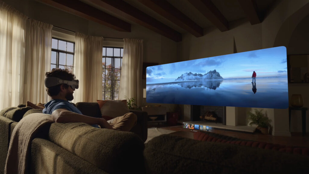 Man using the Apple Vision Pro to watch a movie via spatial computing