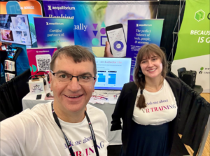 Adrian Moise (CEO) and Isabela Moise (Project Coordinator) catching a selfie in front of the Aequilibrium booth